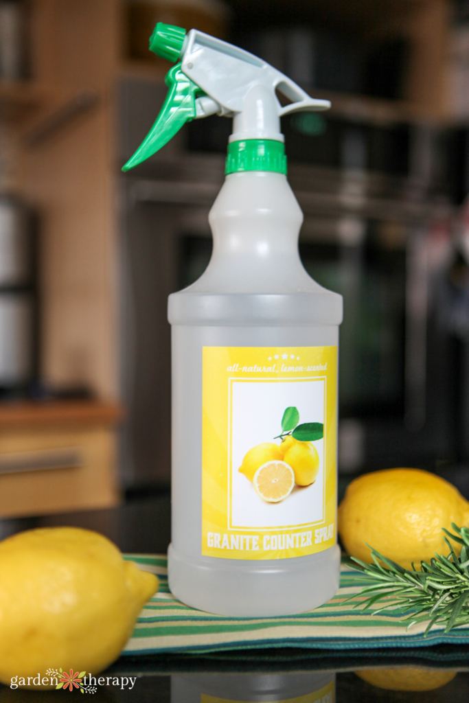 DIY granite cleaner with lemon and rosemary on a countertop