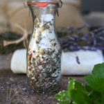 glass lidded vase with diy oatmeal bath mix in it