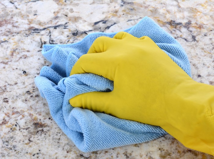 wiping granite countertop with a diy cleaner