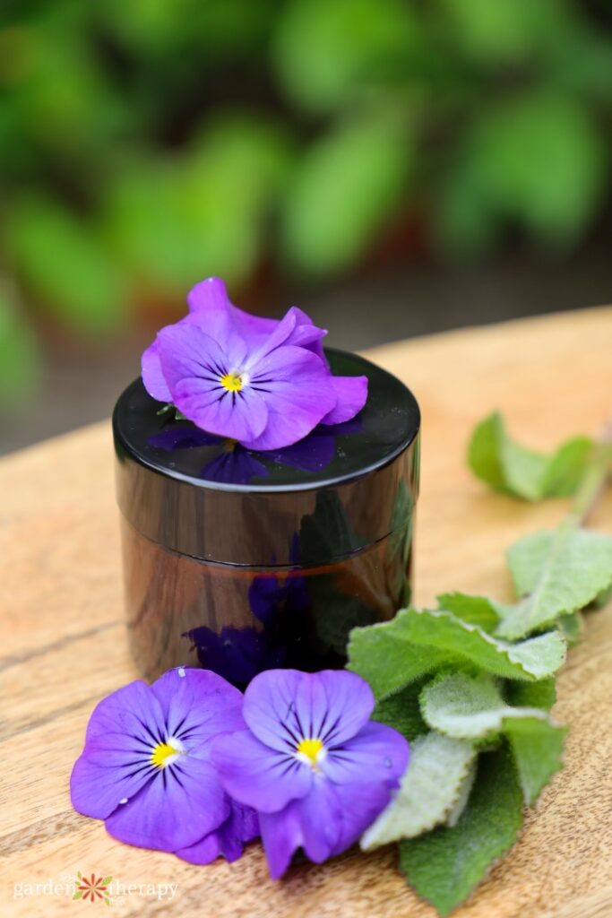 Glass jar with lid screwed on with homemade lotion inside.