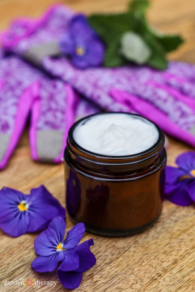 DIY hand cream in a glass jar with purple accents