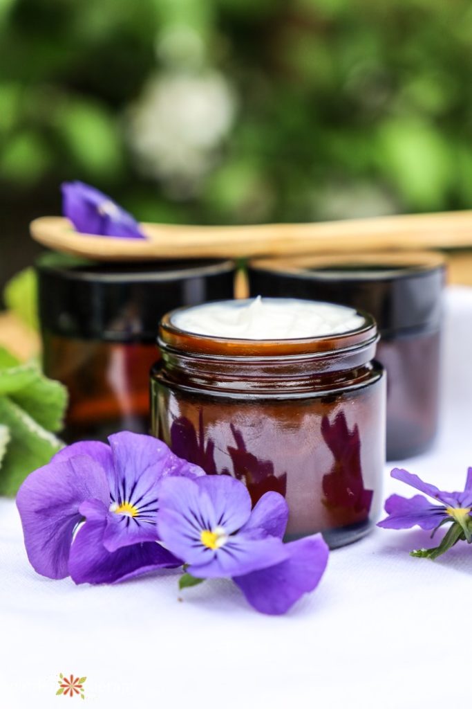 Amber jars filled with homemade hand lotion