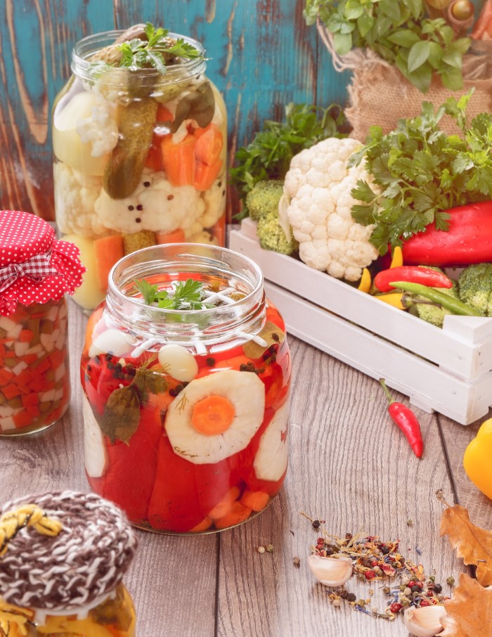 Various pickled veggies in open jars