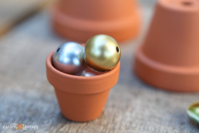 small terracotta pot holding beads