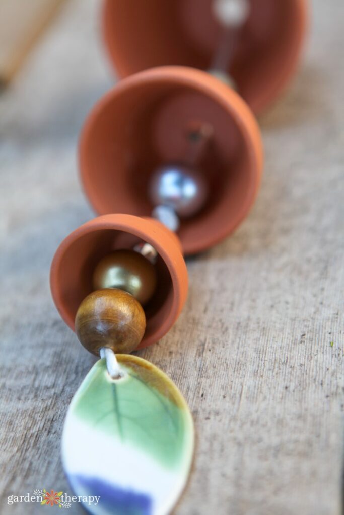 DIY terracotta pot wind chime lying on a table