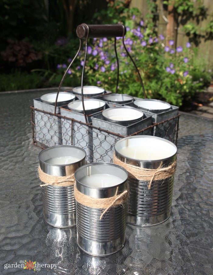 Homemade citronella candles in cans on a table