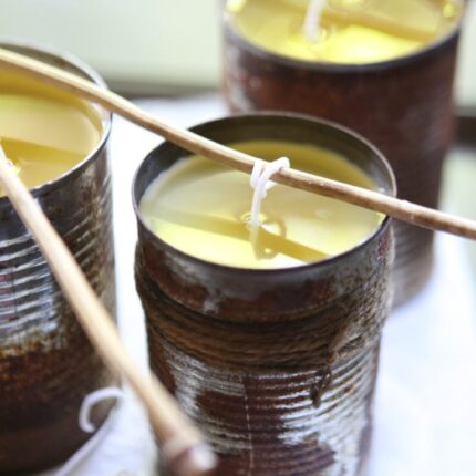 DIY citronella candles cooling down with wicks being propped up with bamboo skewers