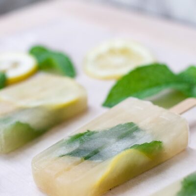 Popsicles on sheet with mint and lemon