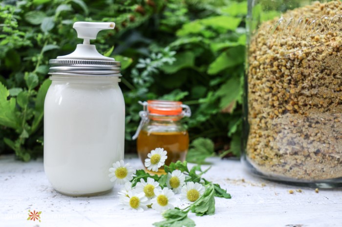 Magnesium lotion next to chamomile flowers