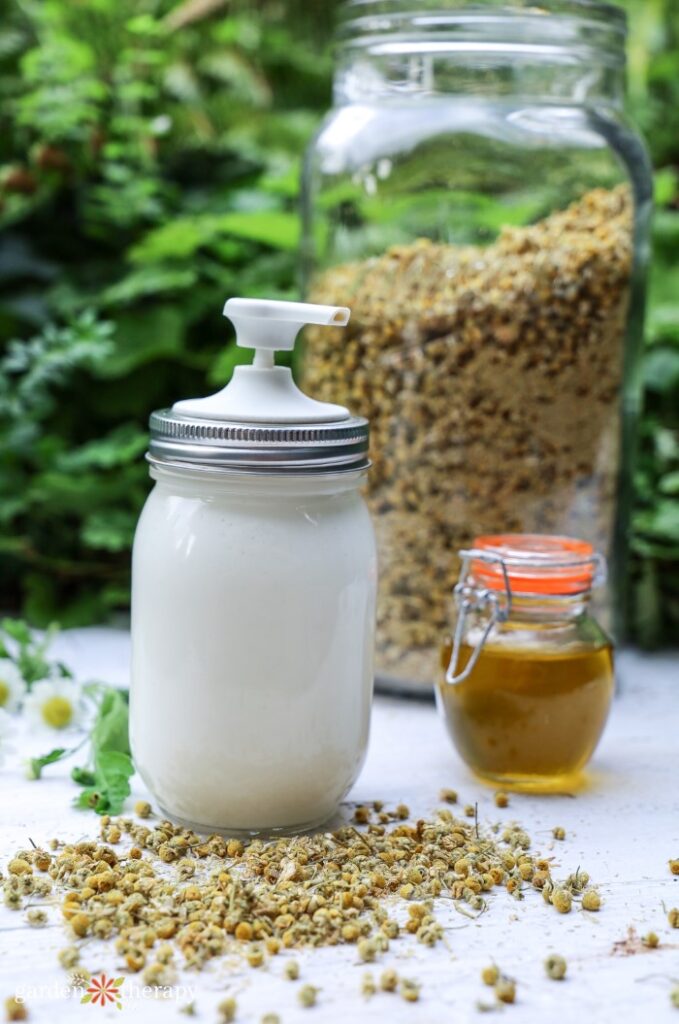 magnesium lotion bottle and dried chamomile flowers