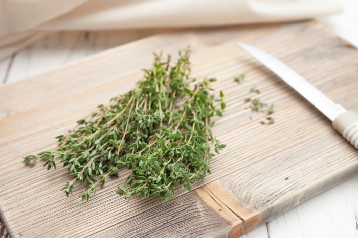 fresh thyme on a wooden cutting board