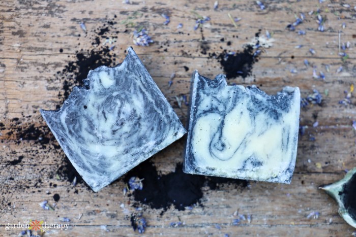 swirled charcoal soap for maskne with charcoal powder underneath