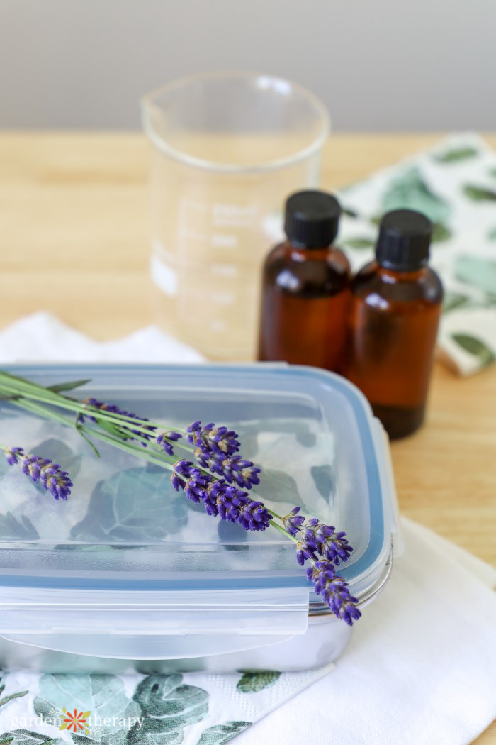 homemade travel wipes in reusable container with lavender