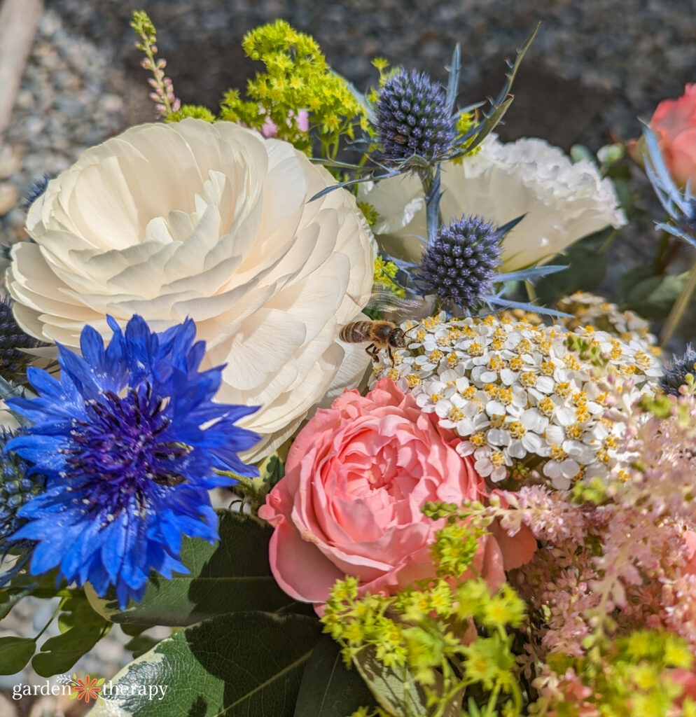 Ranunculus, cornflower, yarrow, and sea holly bouquet