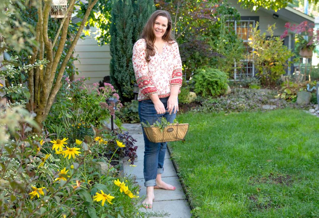 Stephanie standing in garden barefoot