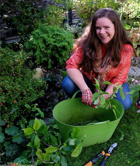 Stephanie in the garden gathering herbs