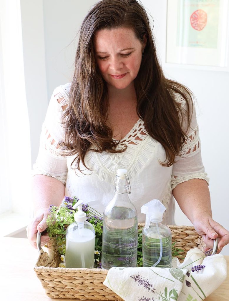 Stephanie holding tray of herbs and bottles