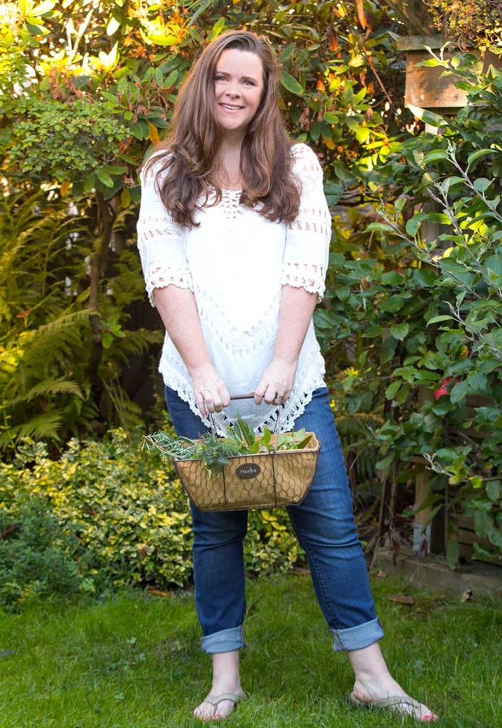 Stephanie Rose holding a basket of herbs