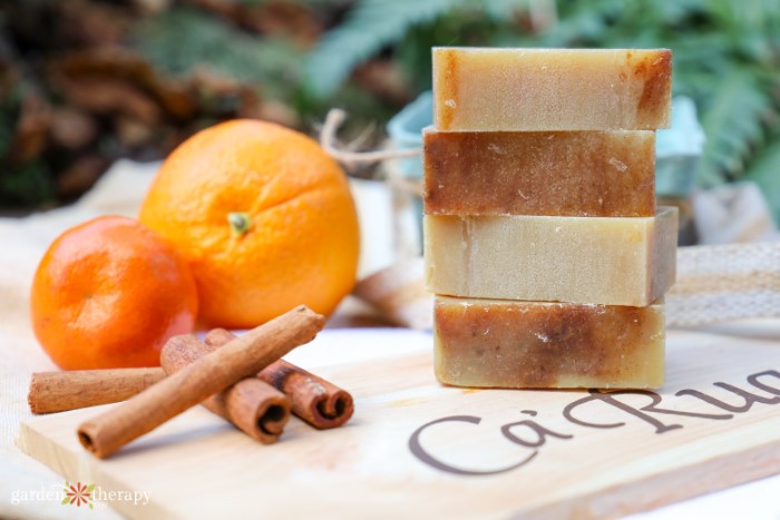 stacked Christmas soap next to oranges and cinnamon sticks