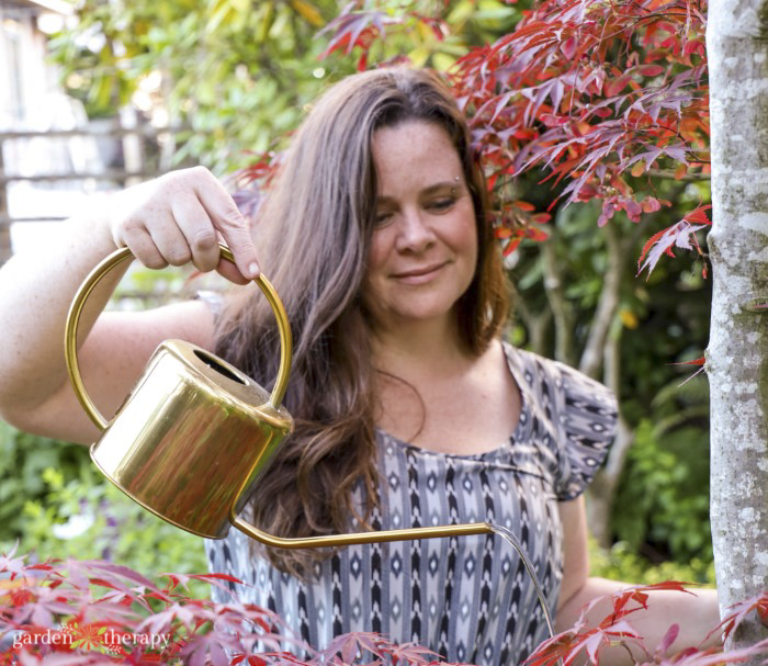 Woman with watering can filled with conserved water