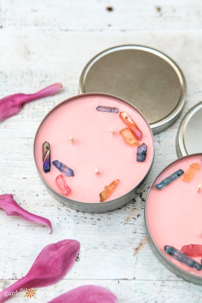 metal tins filled with pink crystal candles