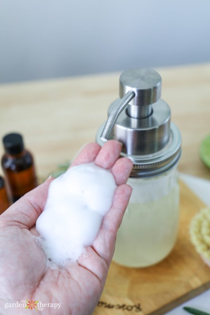 handful of foaming soap next to pump