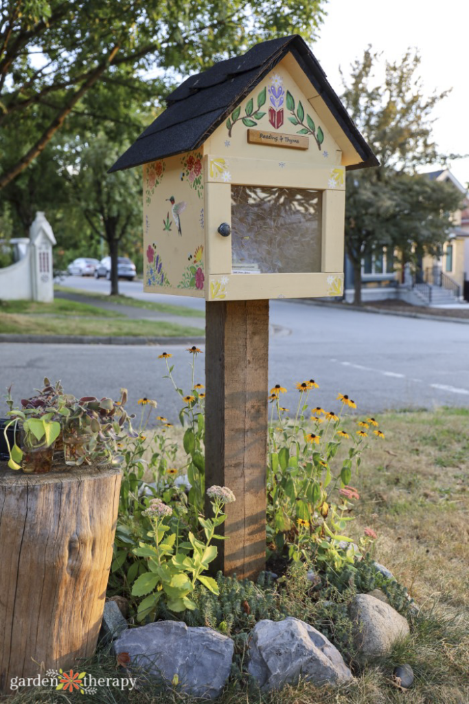 painted seed library in a front yard