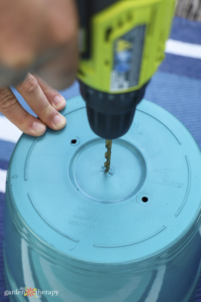 drilling hole into bottom of pail