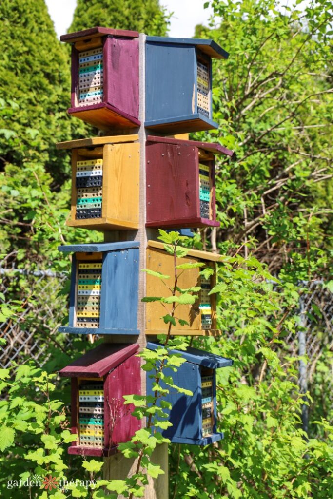 stacked bee houses on a pole