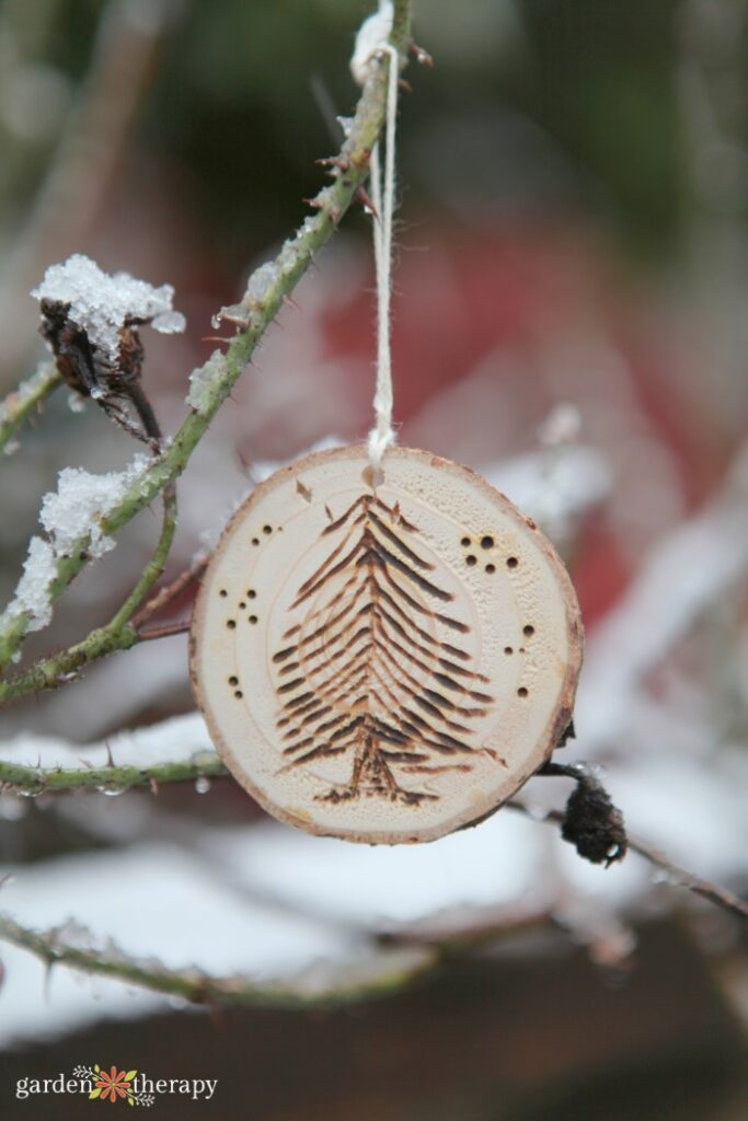 wood slice Christmas ornament made with a woodburned christmas tree