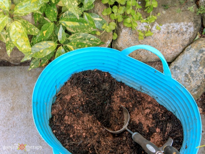 bin of soil and scoop