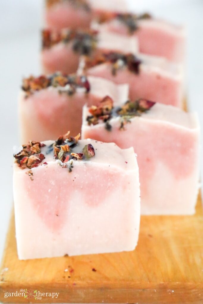 rose soap on wooden cutting board