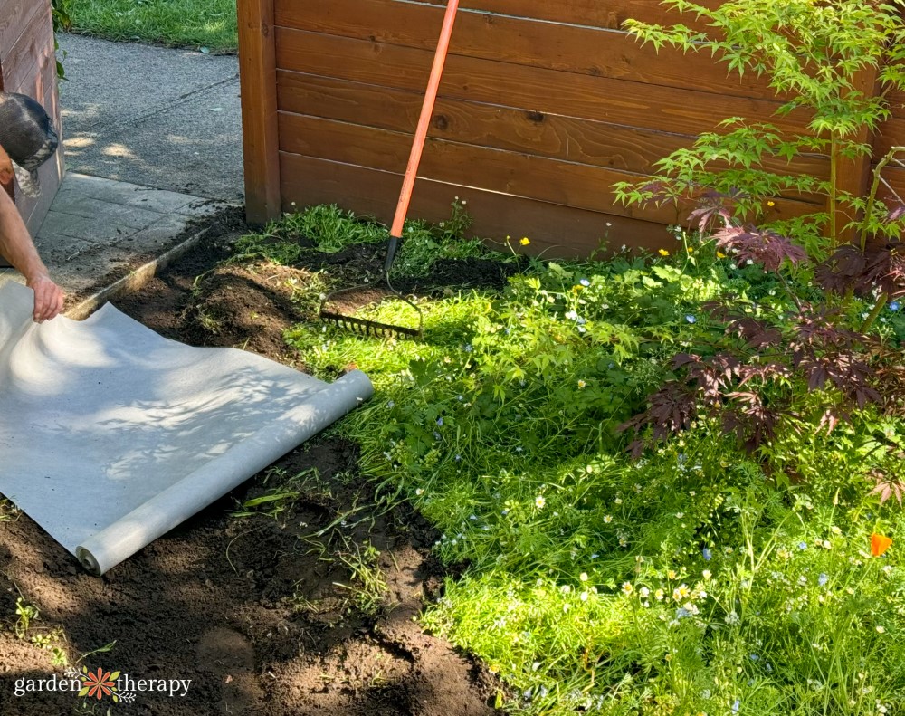 adding landscape fabric to dry river