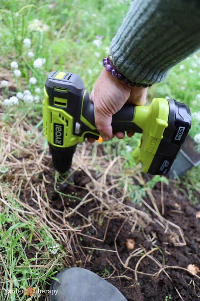 power planter drilling into ground for bulbs