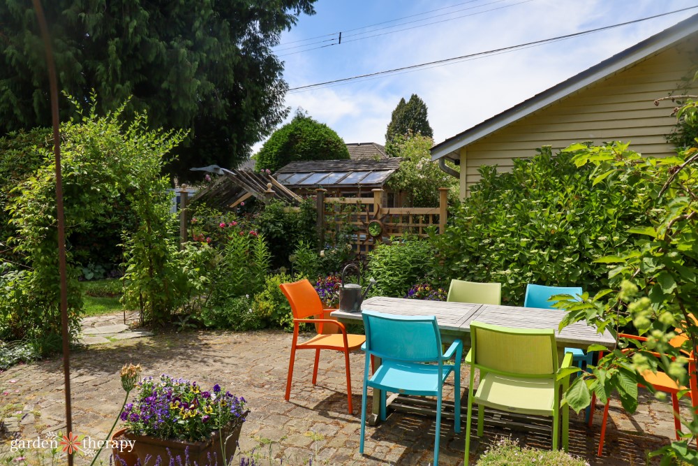 colourful chairs around patio in artist's garden