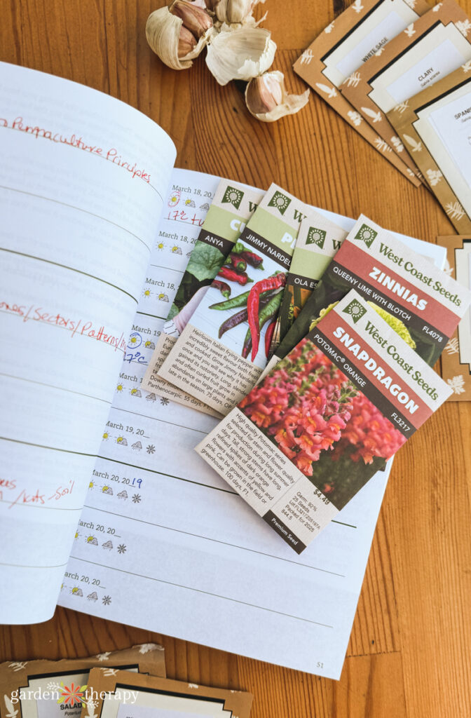 open gardening journal with seed packets