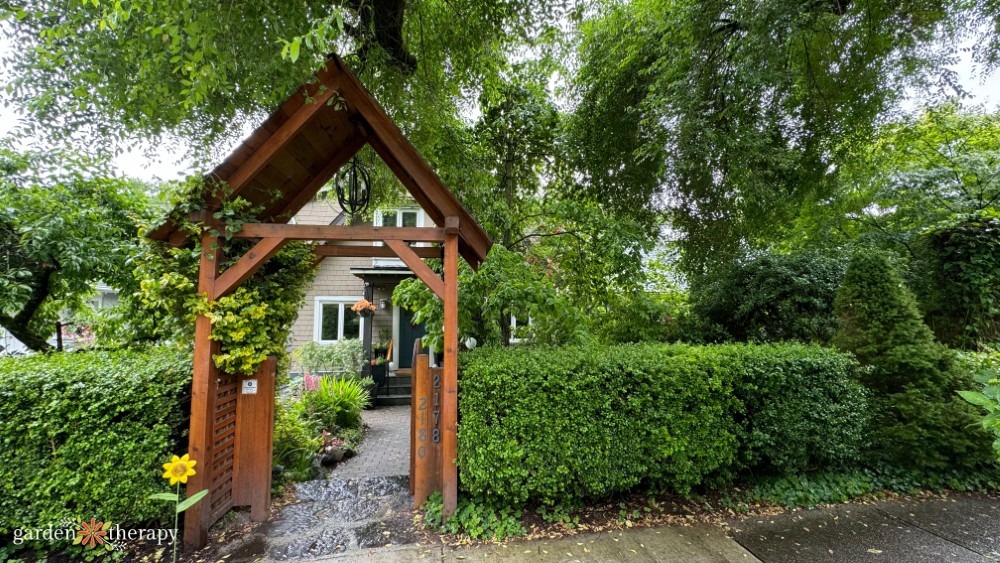 East Vancouver house with wooden entry arbor and low hedge