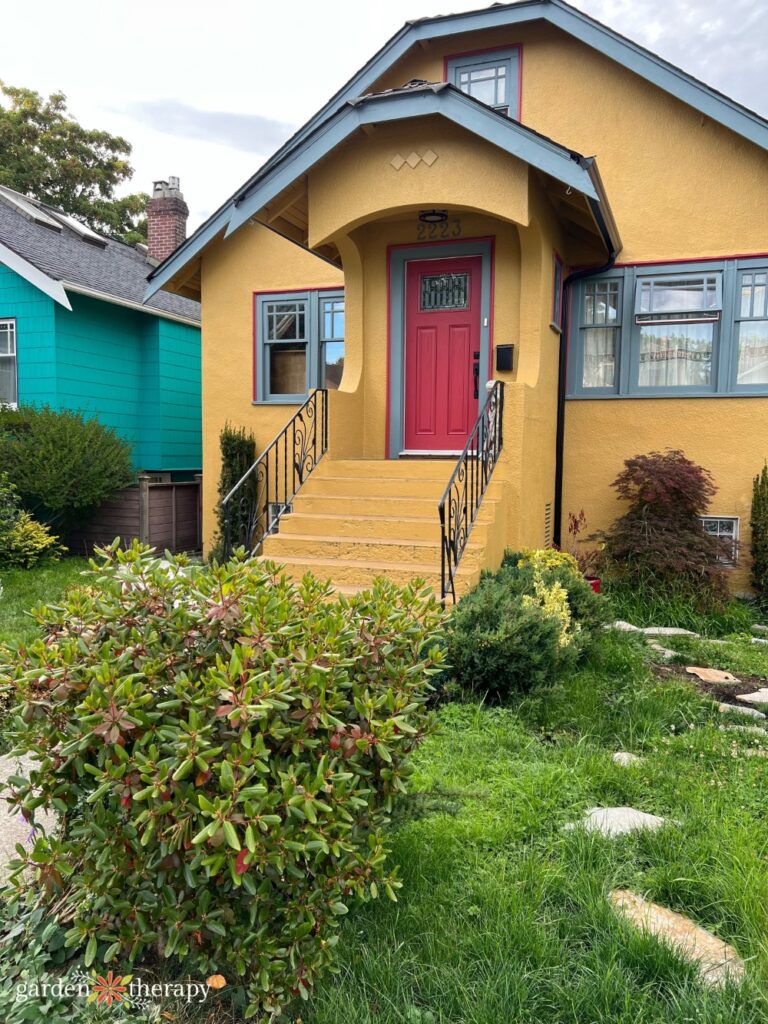 yellow bungalow in East Vancouver with red front door