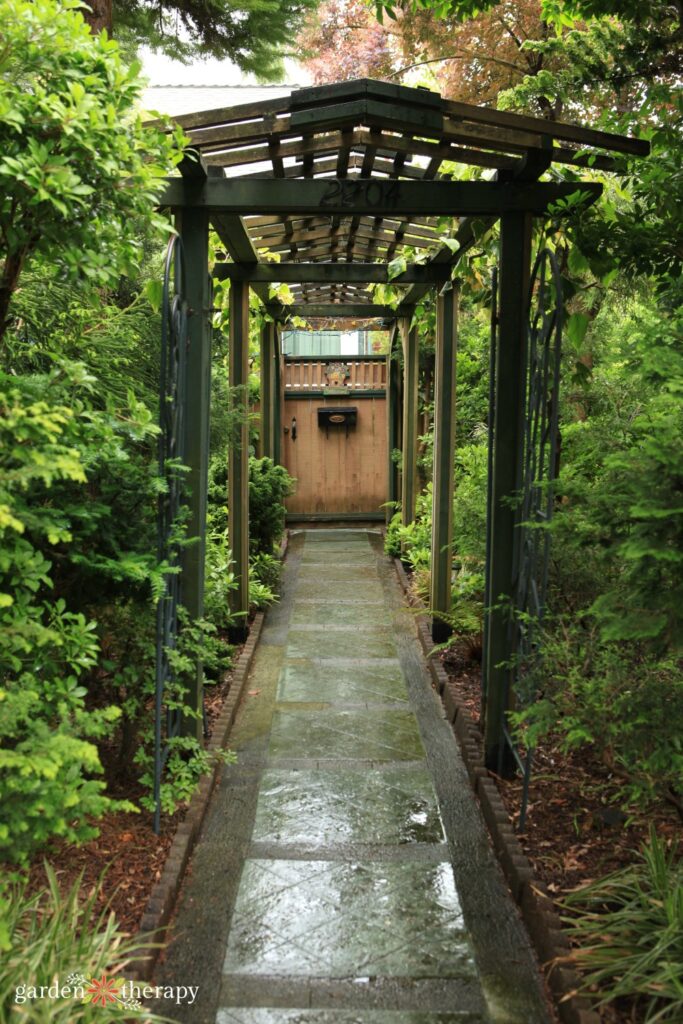 entrance to East Vancouver house through a green garden tunnel