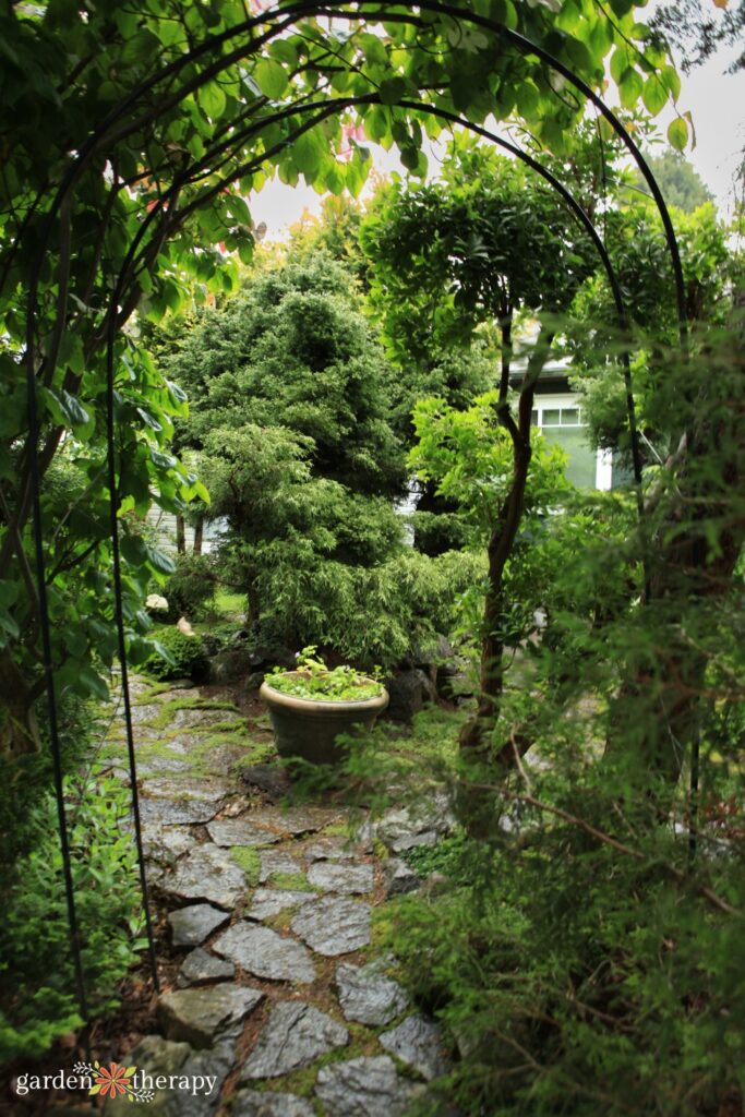 stone walkway through garden arch