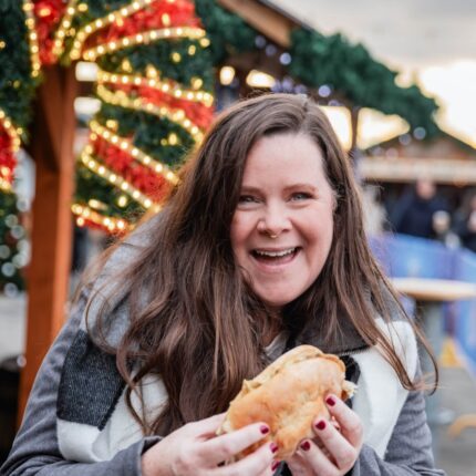 Stephanie holding food at Christmas market