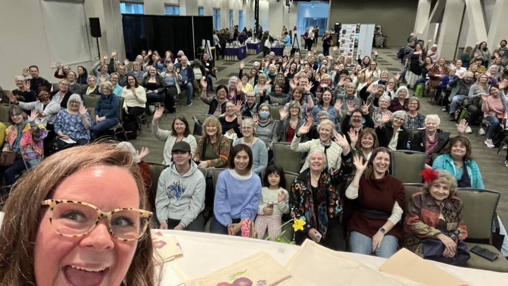 Stephanie at event taking selfie with the crowd
