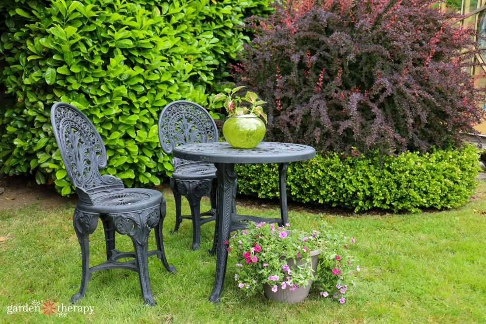 Wrought iron patio chairs in garden