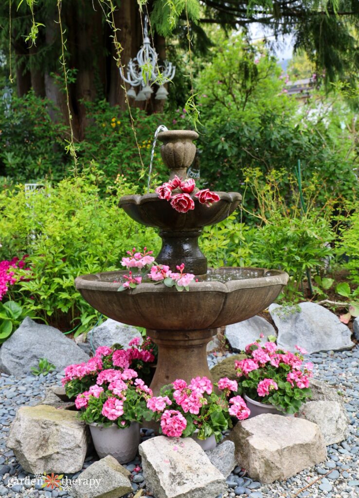 large tiered fountain with pink flowers