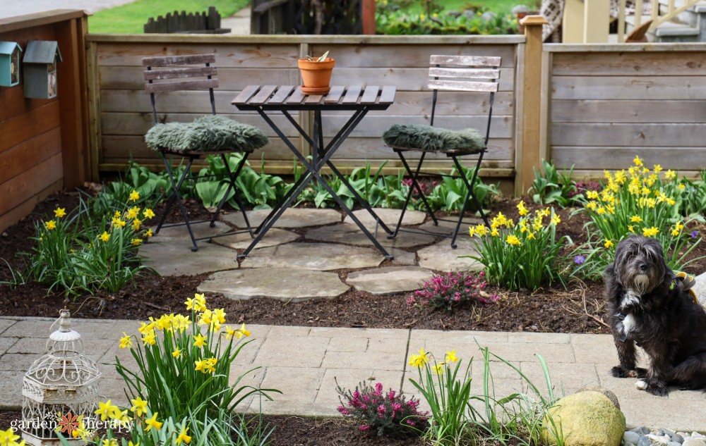Front yard patio with stone work and blooming spring bulbs