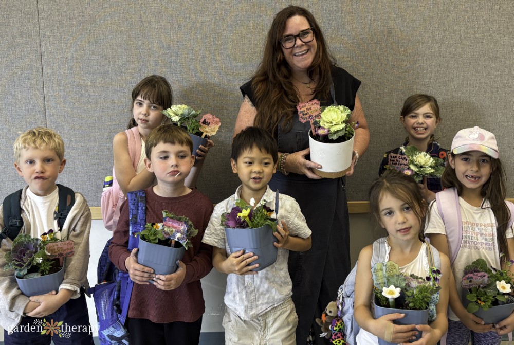 Stephanie and kids smiling holding their bee breakfast planters