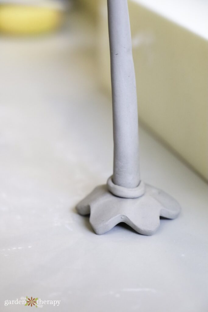 adding clay ring to base of bee cup